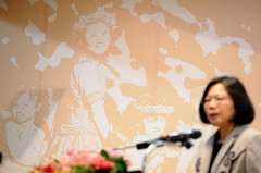 President Tsai and the portraits of indigenous peoples on the wall.